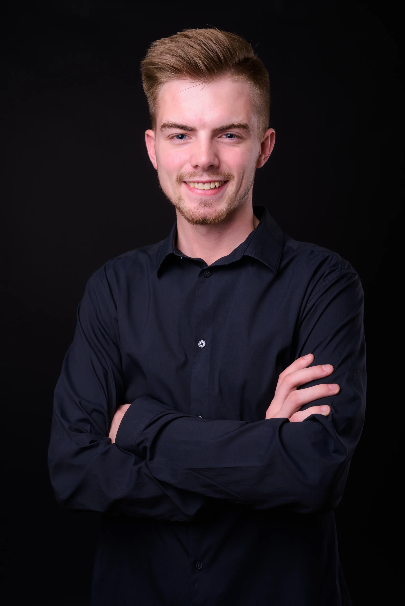 studio-shot-young-handsome-businessman-against-black-background